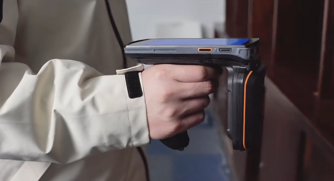 Industrial handheld RFID reader for inventory powering a battery-free real-time location system.