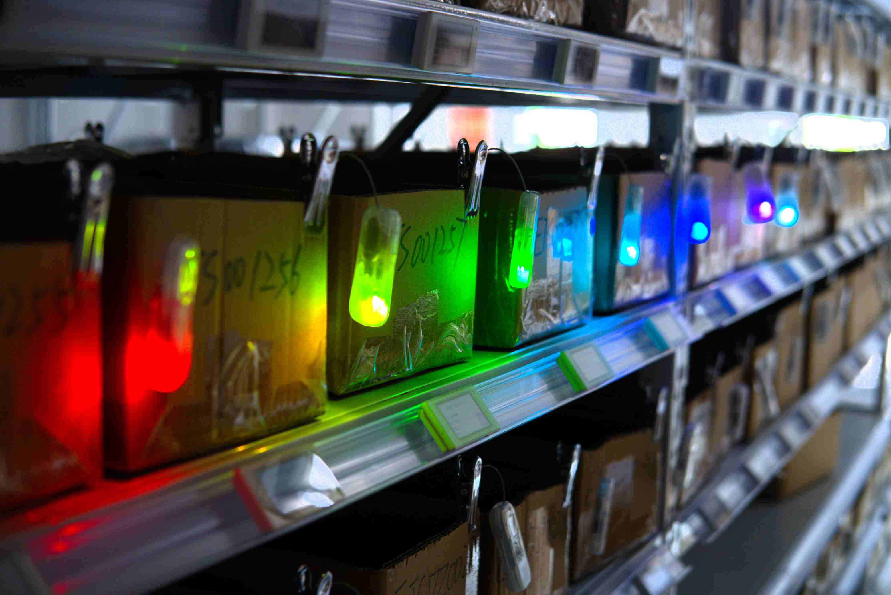 A detailed shot of a rugged FYJ Sound and Light tag attached to a wooden pallet in a dusty environment. Built for the Real World: Rugged, dust-proof, and high-intensity IoT tags.
