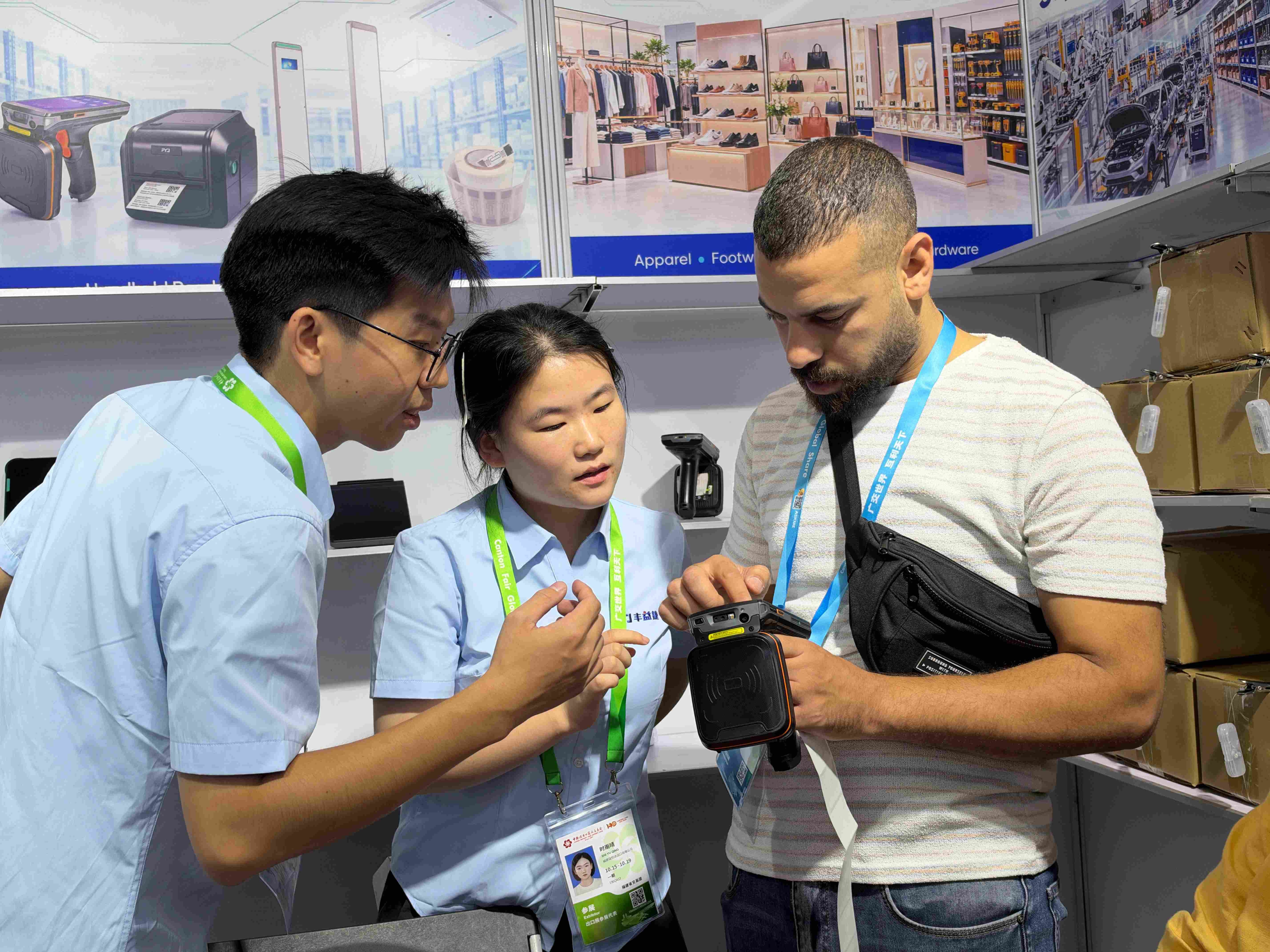 Visitor testing an RFID handheld PDA for batch tag reading and packaged goods identification at the FYJ booth